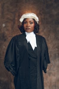 Confident young female lawyer in a traditional gown and wig.
